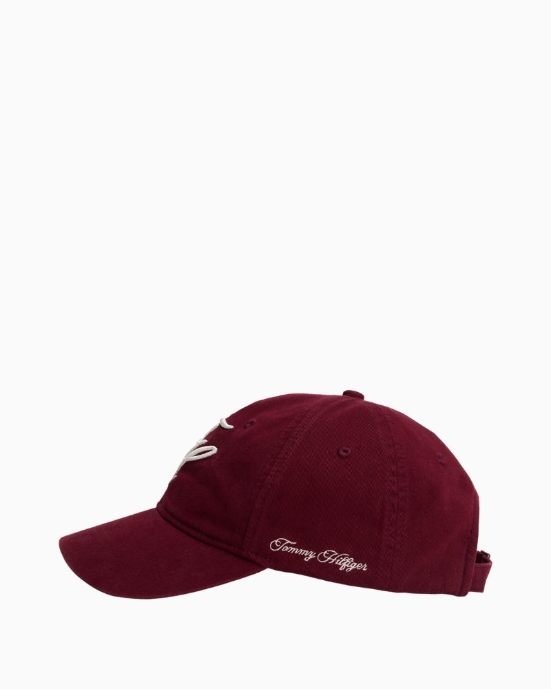 Side profile of red cotton cap with curved brim