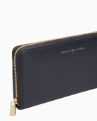 Side view of navy Tommy wallet with zip closure and slim profile