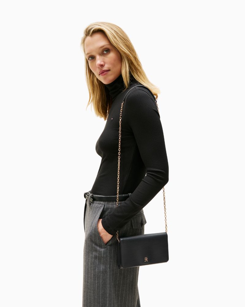 Model view of TH Icon chain bag in faux leather showing flap closure and structured shape