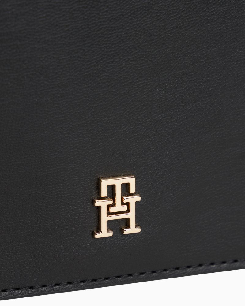 Close up view of TH Icon chain bag in faux leather showing flap closure and structured shape