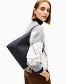 Tommy Hilfiger monogram shoulder bag styled with casual outfit