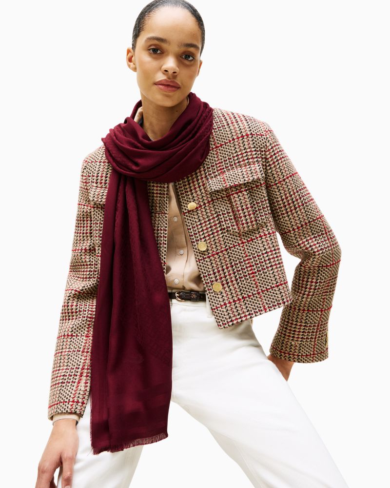 Model of Tommy scarf showing soft fabric and tonal monogram print