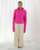 Oversized neon pink jumper with trucker-style collar and soft finish