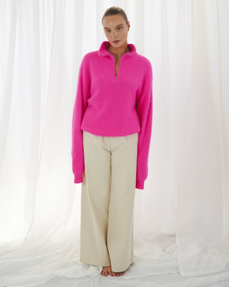 Oversized neon pink jumper with trucker-style collar and soft finish