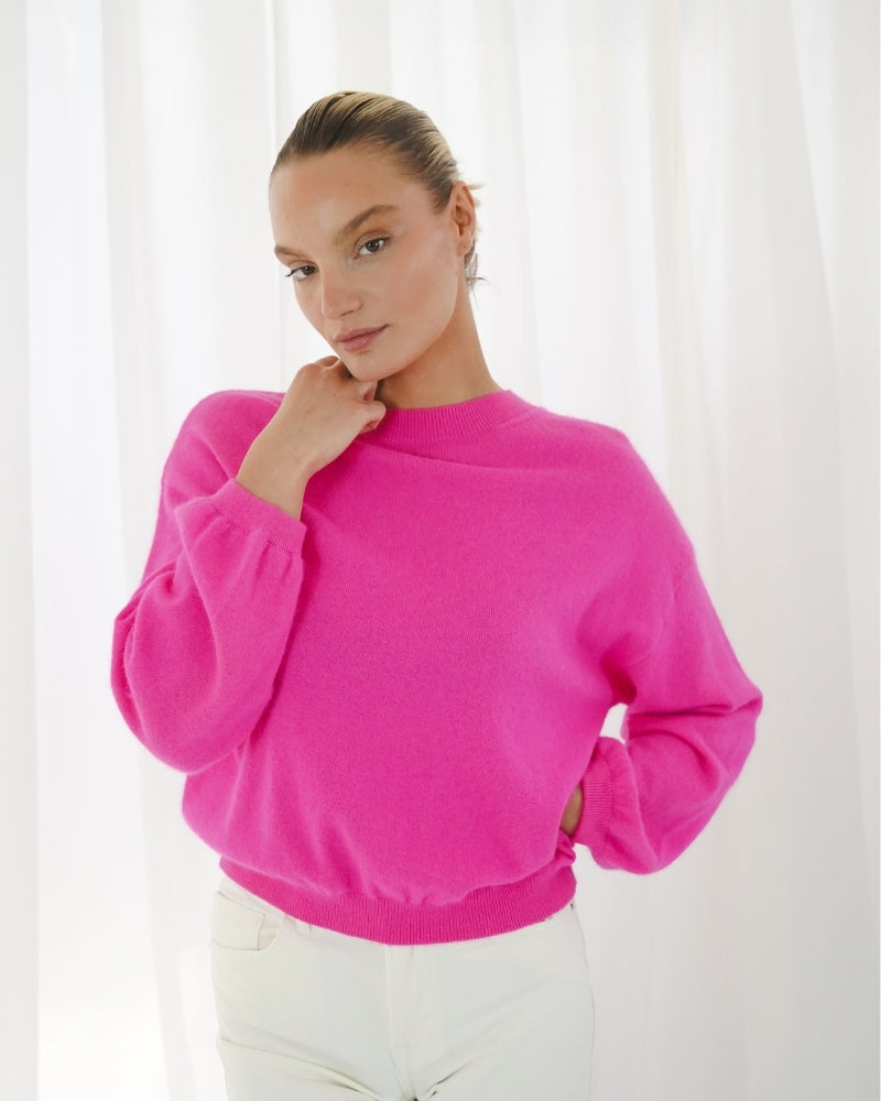 ¾ sleeve oversized sweater in vibrant pink, styled casually