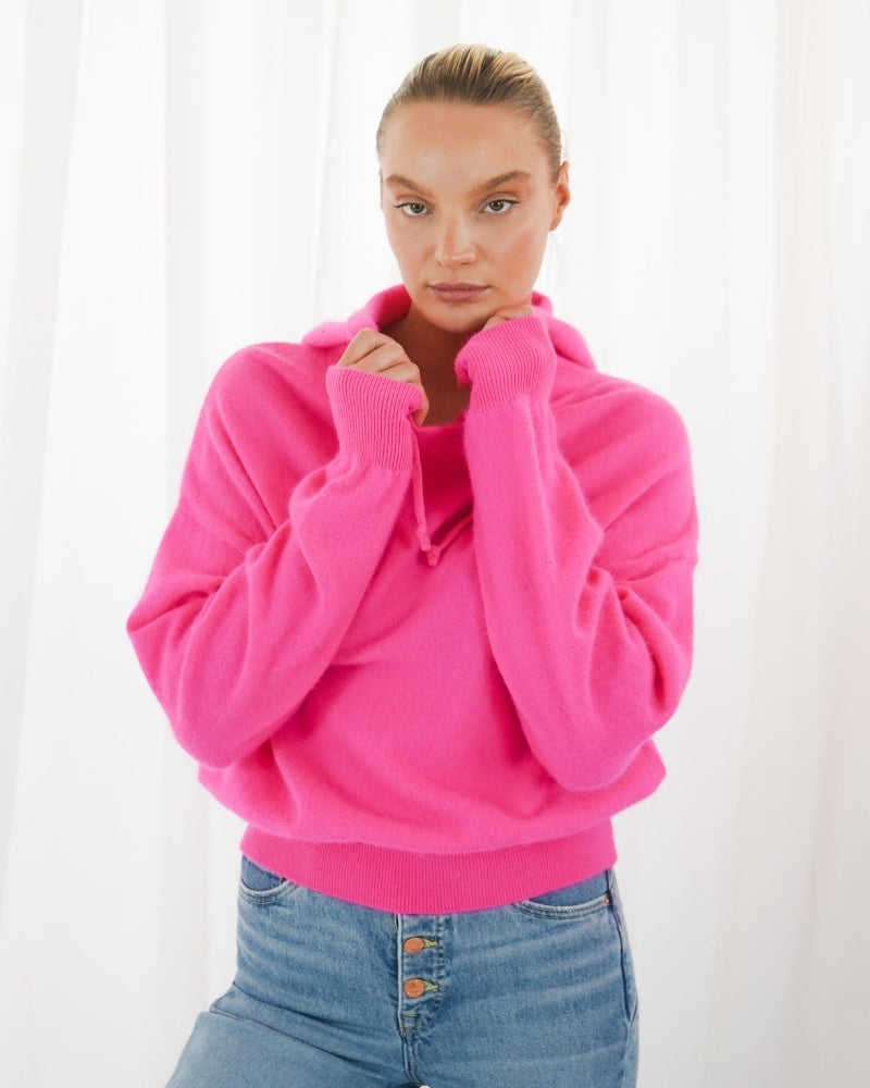 Oversized pink hoodie with gathered sleeves and soft knit texture