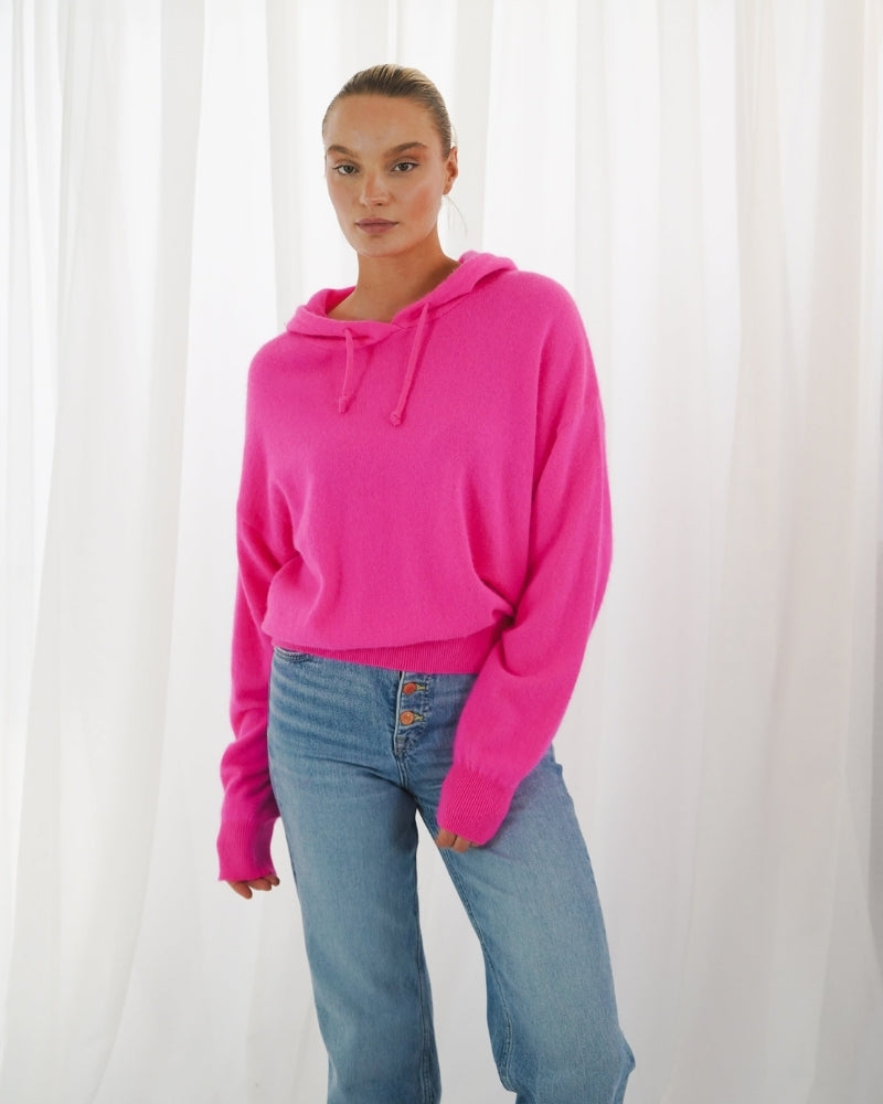 Oversized pink hoodie with gathered sleeves and soft knit texture