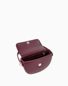 Interior view of small flap bag with multiple compartments and fabric lining