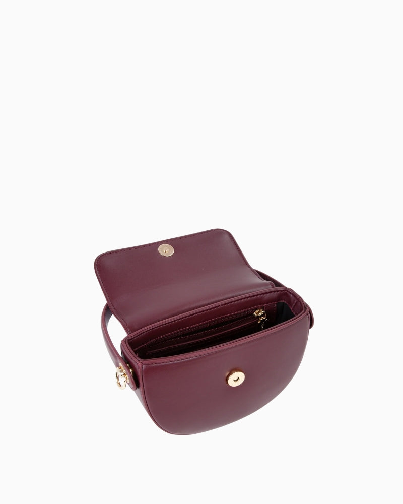 Interior view of small flap bag with multiple compartments and fabric lining