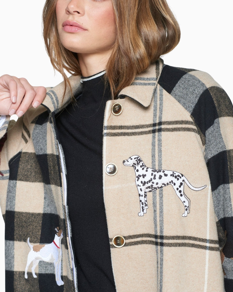 Close-up of embroidered dog motifs on Vilagallo Berenice coat sleeve