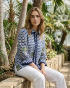 Woman wearing Vilagallo ikat palm print shirt blue and white – Áines Boutique