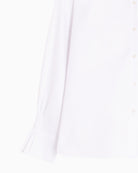 Detail view of double cuff with ruffle finish and metallic button