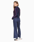 Model wearing Vilagallo Bettina dark blue denim trousers, back view