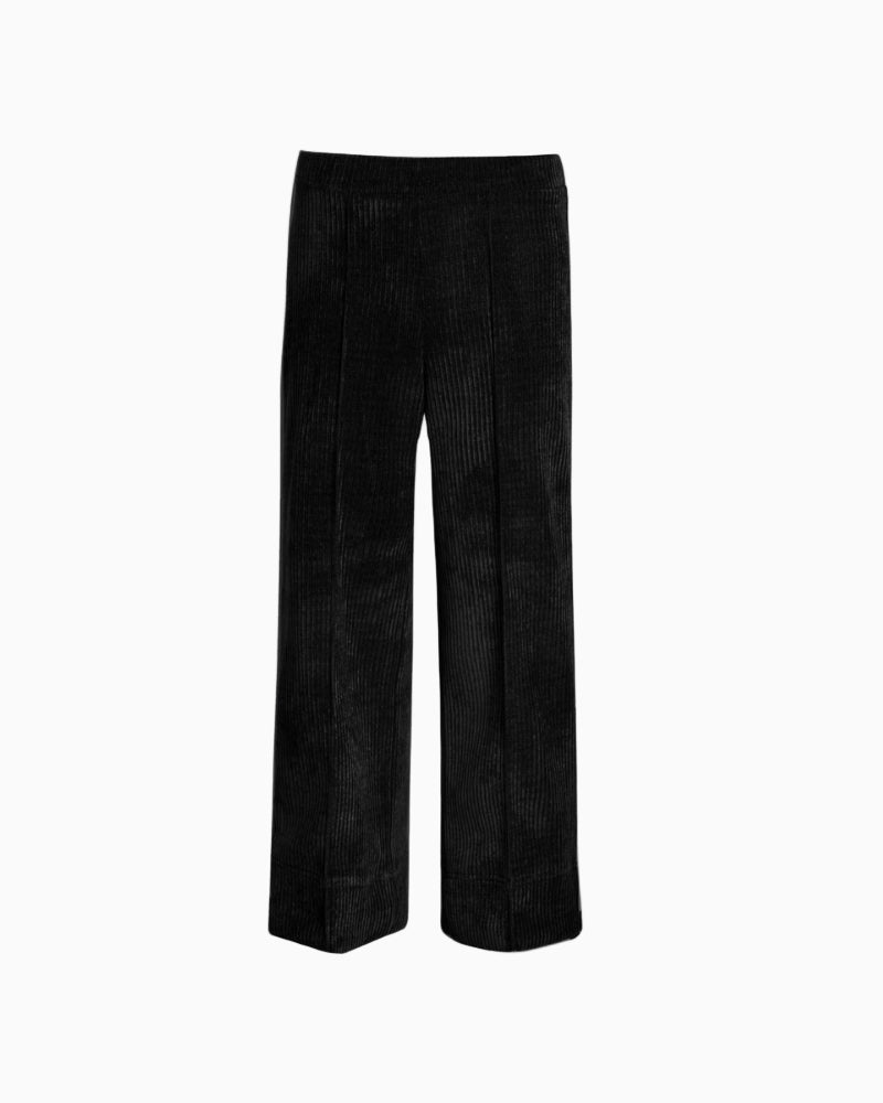 Close-up detail of ribbed corduroy fabric and central seam on tailored trouser