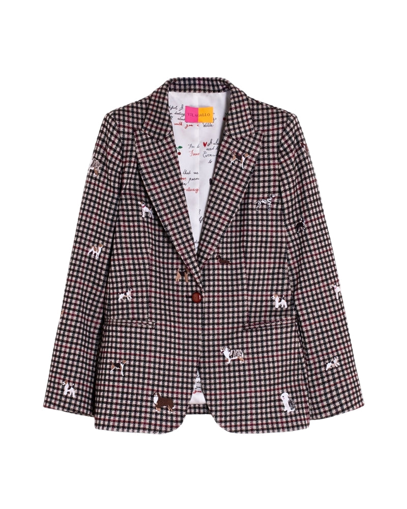 Close-up of embroidered dog motifs on beige, black, and burgundy blazer