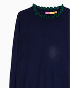 Close-up of green ruffle detail on cuff of Vilagallo navy knit jumper