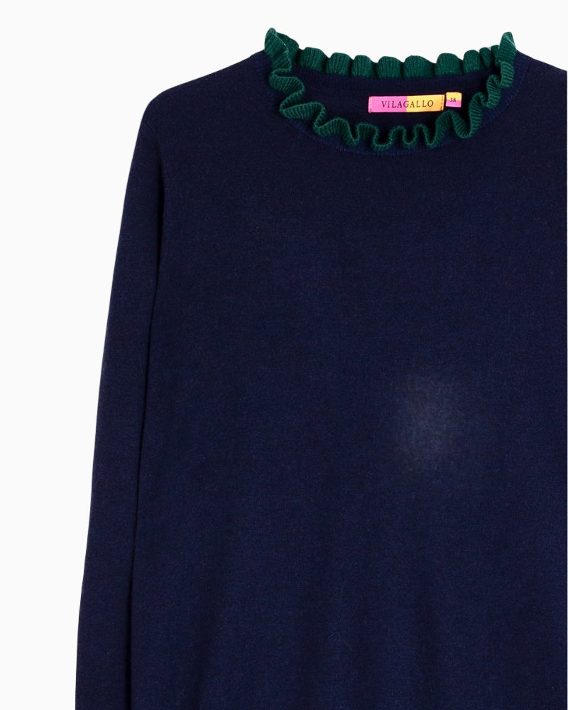 Close-up of green ruffle detail on cuff of Vilagallo navy knit jumper