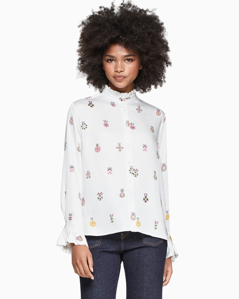 Model wearing Vilagallo Nicola shirt with ruffle collar and pleated cuffs
