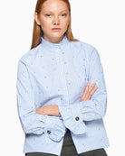 Close-up of frilled collar and ruffle cuff details on Vilagallo shirt