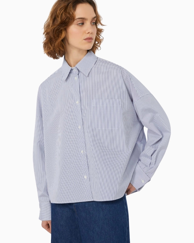 Close-up of shirt collar, button fastening, and wide cufflink cuffs