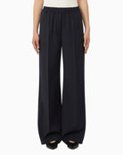 Woman wearing Weekend Max Mara wool trousers navy, front view – Áines Boutique
