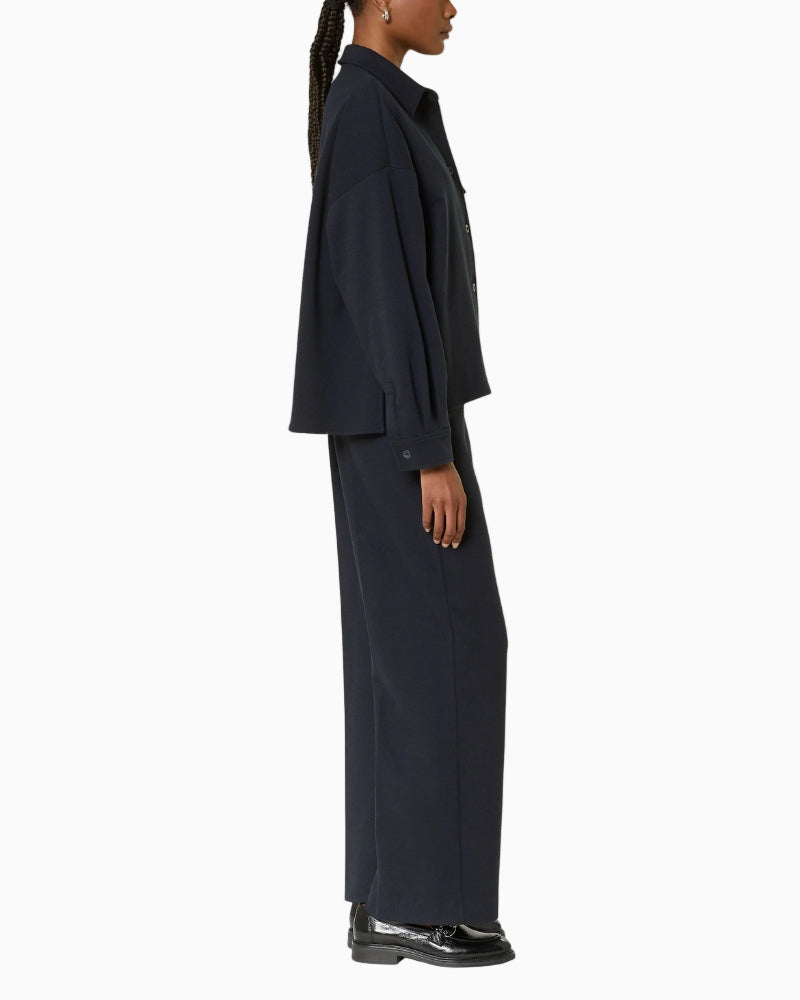 Side view of model in Max Mara Zelota trousers, showing wide-leg cut and soft drape.